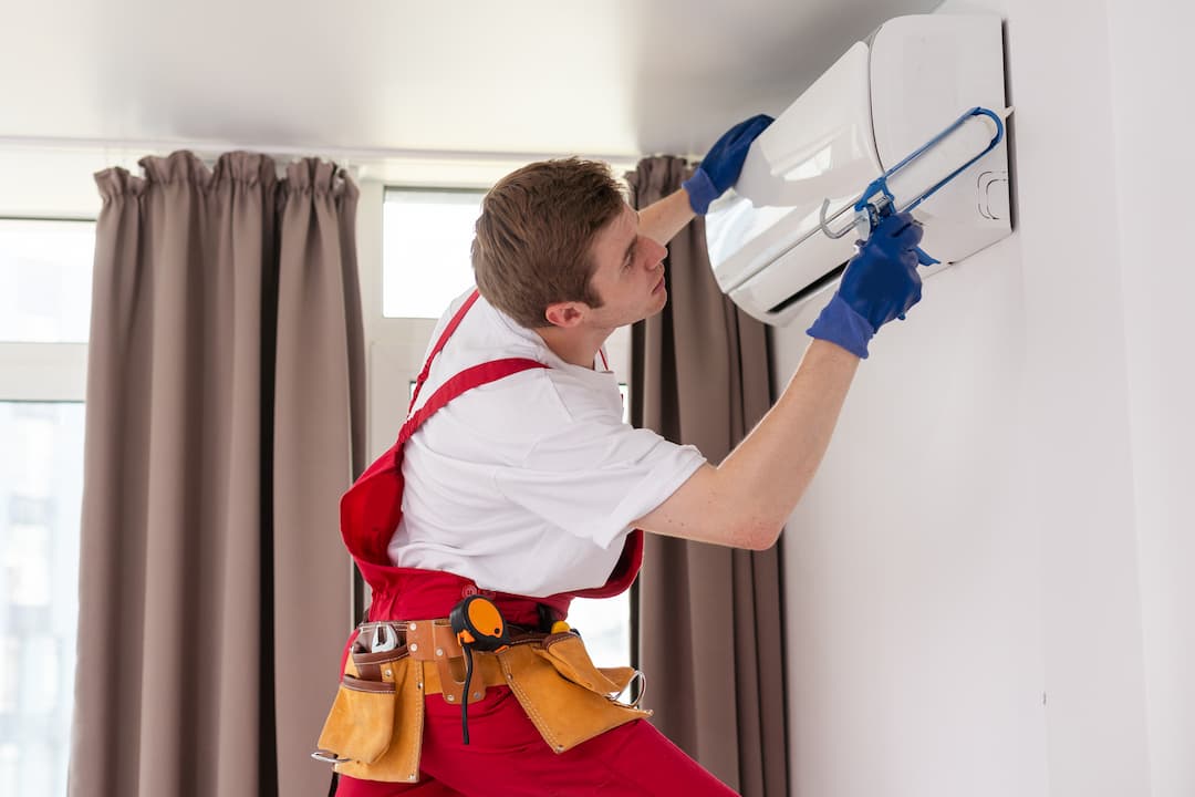 A man is repairing AC